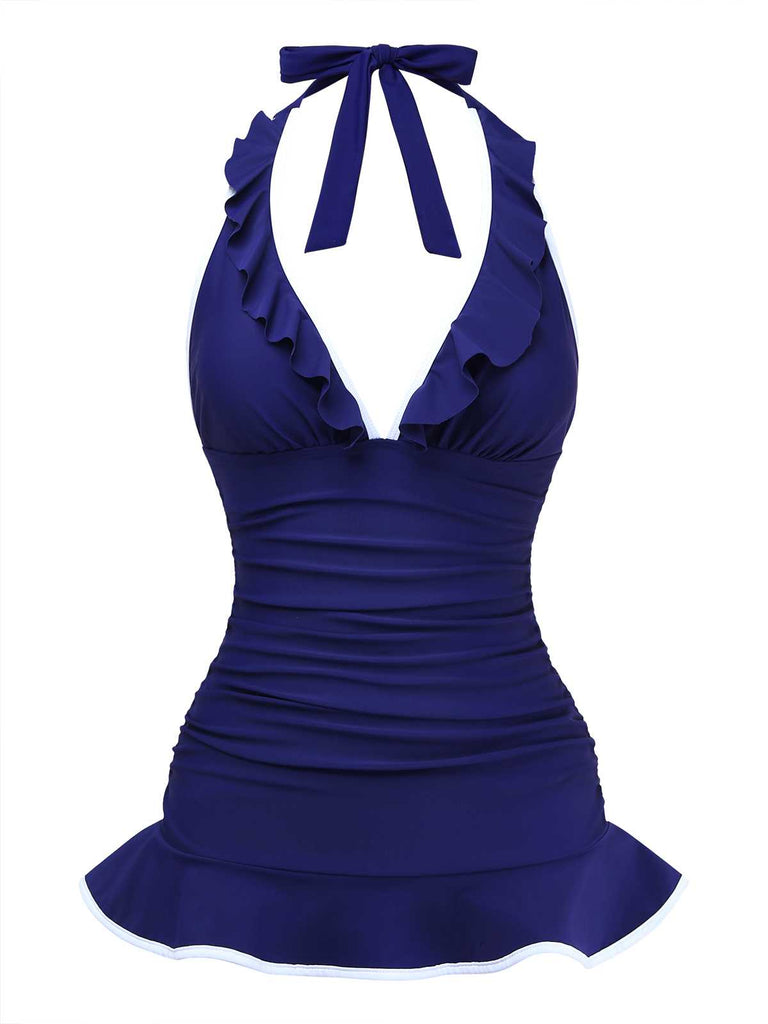Vorderansicht der marineblauen Version des Rüschen-Neckholder-Badeanzugs, bei der der geraffte Stoff mit Bauchkontrolle besonders zur Geltung kommt.