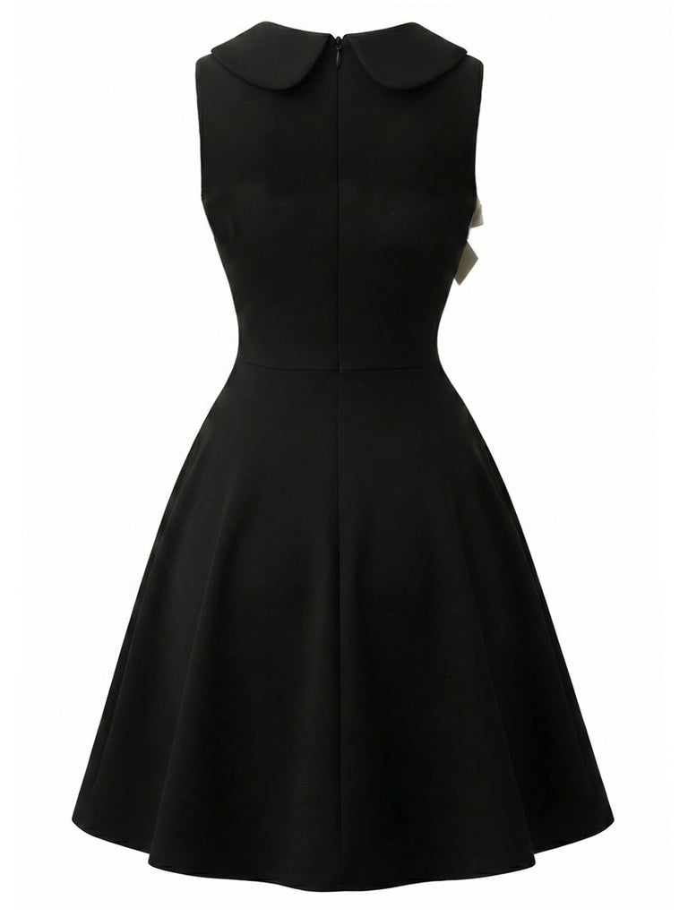 Schwarzes 50er Kleid mit apricotfarbenem Spitzenbesatz und Schleife