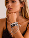 Schwarzes Lederarmband mit Stern und mehrreihiger Kette