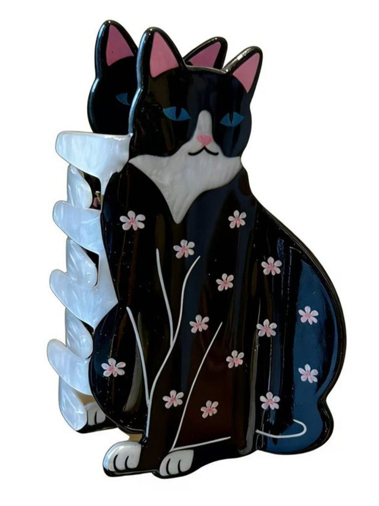 Schwarz-weiße katzenförmige Haarspange mit Blumenmuster