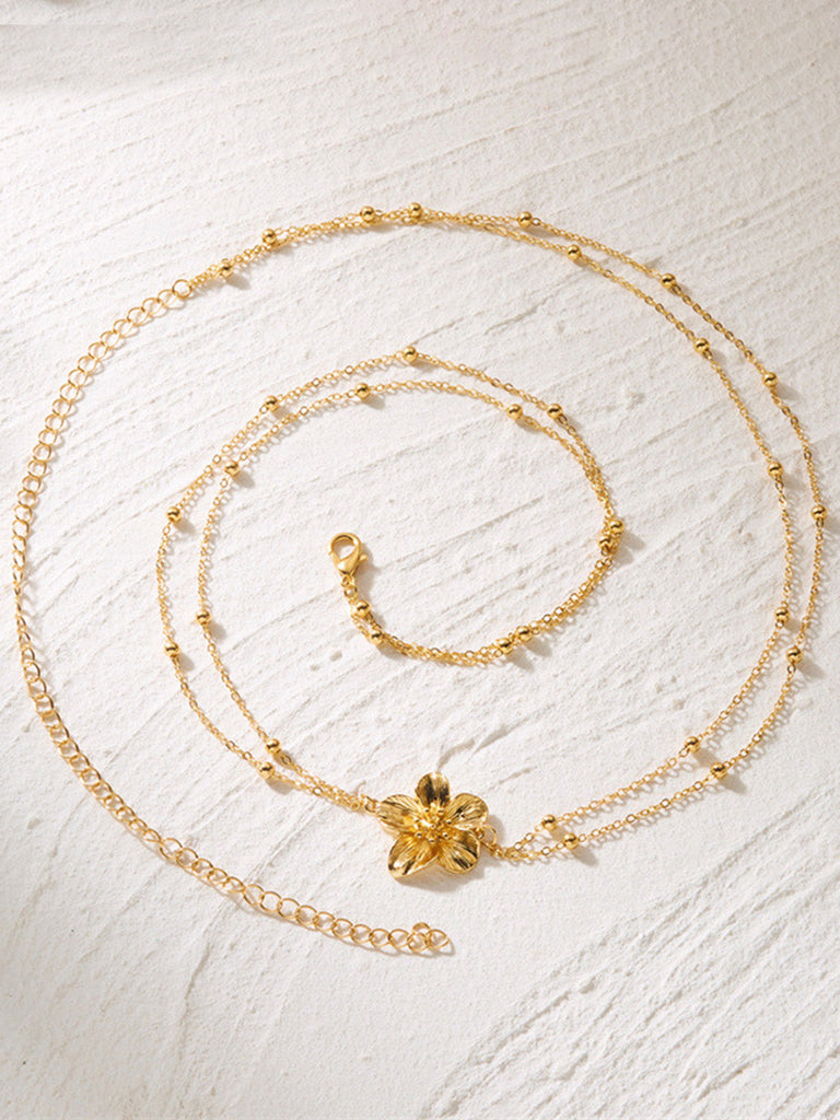 Golder Body mit Blumen und Perlen