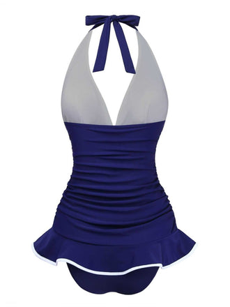 Rückansicht des marineblauen Badeanzugs mit Rockteil, die die bequeme Passform und die elegante Silhouette zeigt.